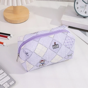 Close-up of purple quilted pencil case with cute bear illustrations and metal zipper