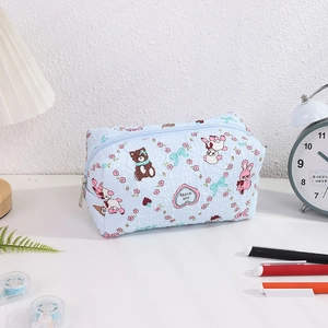 Detailed view of light blue quilted pen case with cute bear and rabbit cartoon patterns