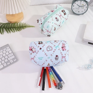 Detail view of light blue quilted pencil case with cute cartoon prints and high capacity