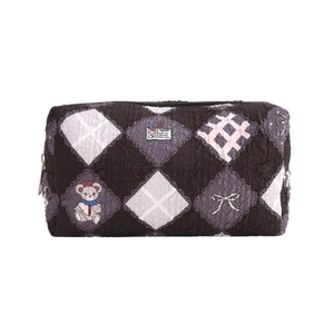 Close-up of quilted floral pencil case with cute cartoon bear and patchwork patterns