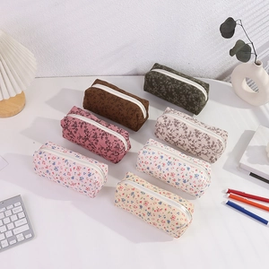 Detailed view of floral corduroy pencil cases in various patterns with zippers