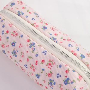 Close-up of pink floral corduroy pencil case showing fabric texture and metal zipper