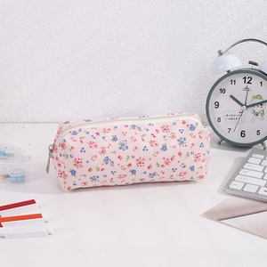 Floral canvas pencil case with a metal zipper on a desk for stationery storage