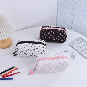 Three-piece quilted bow print cosmetic bag set featuring lightweight zip storage organizers