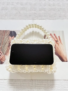 Elegante weiße Rosen-Perlentasche mit Perlenhenkel und Smartphone für Größenvergleich