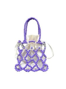 Detail of hand-woven beaded handbag with purple mesh pattern and satin drawstring pouch