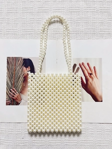 Elegant white faux pearl beaded tote bag with rectangular frame and long handles