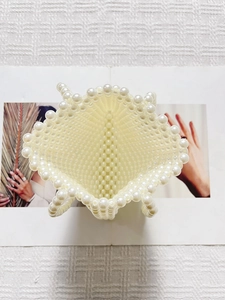Minimalist cream white pearl beaded crossbody bag featuring woven texture and internal space
