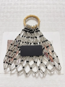Handmade beaded mesh tote with silver beads and bamboo handles for beach or casual use
