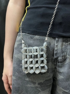 Detail of gray beaded mini crossbody bag with smoky translucent resin beads and chain