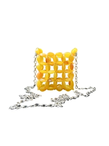 Macro detail of yellow acrylic beaded crossbody bag with hollow woven mesh structure