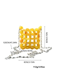 Detail view of yellow acrylic handmade beaded mini bag with silver metal chain strap