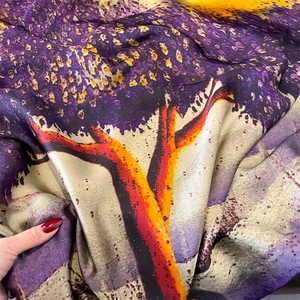 Artistic silk satin scarf featuring vibrant orange and yellow abstract print on dark purple