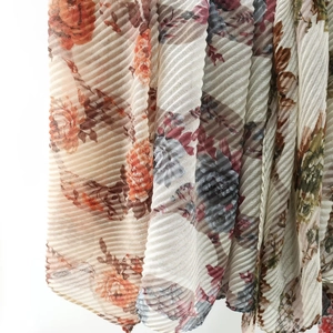 Macro detail of plissé pleated floral fabric showing vintage print and textures