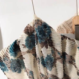 Close-up of lightweight floral printed voile scarf with elegant wrinkled texture and drape