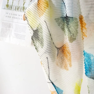 Detail of crinkled voile shawl showing watercolor ginkgo leaf prints and pleated texture