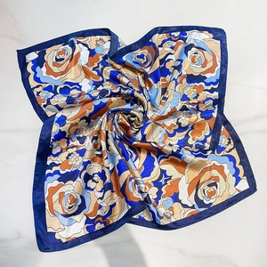 Vintage floral satin square scarf with deep blue borders on marble background