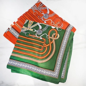 Silk square scarf with equestrian patterns in orange and green on marble background