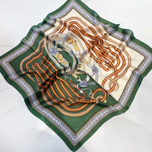 Green and cream satin square scarf with chain equestrian print on marble background