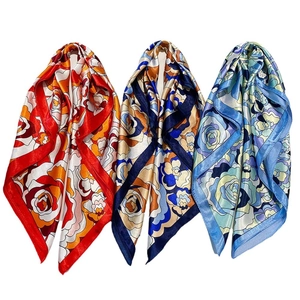 Three vintage floral satin square scarves in red, blue, and purple silk-like fabric