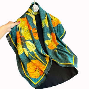 Elegant 90cm silk satin scarf featuring bold yellow floral patterns on dark green