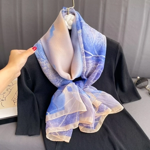 Lightweight gradient silk scarf shawl in blue and lilac displayed on a black knit top