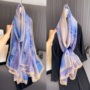 Lightweight floral silk scarf with elegant blue landscape print for beach sun protection