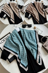 Detail of silk-like scarf featuring geometric circle prints in beige, brown, and light blue
