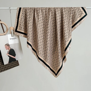 Champagne gold silk square scarf with black circular geometric print and elegant drape
