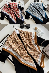 Detail view of large silk-feel square scarves featuring letter prints and geometric patterns
