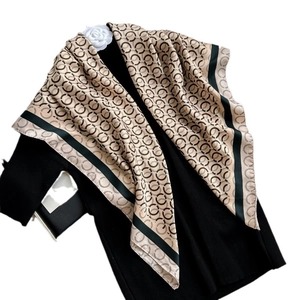 Elegant silk scarf with beige circle prints and deep green borders on black fabric