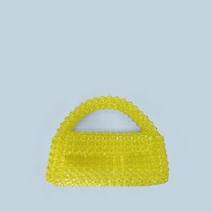 Detailed view of yellow handmade beaded trapezoid handbag with acrylic woven texture