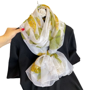 Elegant white silk scarf with vibrant yellow floral patterns and green leaves for women