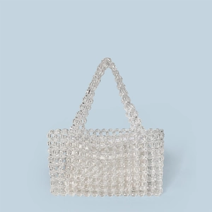 Close-up of handmade transparent crystal beaded handbag with faceted acrylic beads