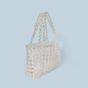 Detailed view of handmade transparent crystal beaded bag with floral woven patterns
