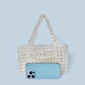 Detail of white crystal beaded handbag with inner pouch and smartphone for scale