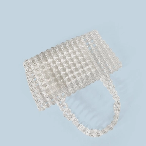 Macro detail of the woven transparent crystal beads and structure of the handmade handbag