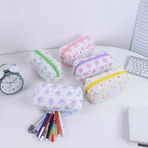 Detailed macro view of quilted floral pencil cases showing large storage capacity