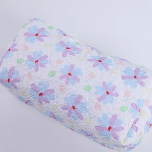 Detail of floral quilted pencil case featuring soft fabric and intricate diamond stitching