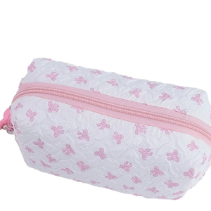 Minimalist white waffle fabric makeup bag with cute pink bow pattern and zipper
