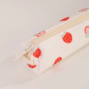 Close-up of strawberry print fabric and durable white zipper on the pencil case