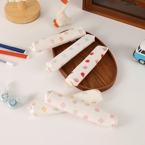 Close-up of waffle texture fabric pencil pouches with strawberry prints on desk