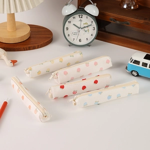 Close-up of five-piece stationery pencil pouch set with colorful fruit prints and waffle texture