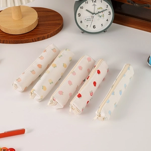 Detailed view of mesh strawberry pencil cases with colorful zippers and fruit prints