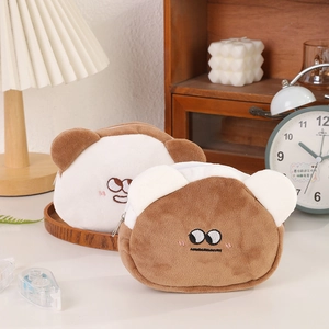 Close-up of cute plush bear coin purses with soft fur and embroidered facial details