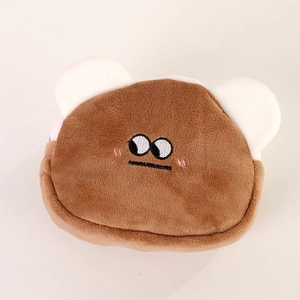 Close-up of cute brown plush bear coin purse with soft texture and detailed embroidery