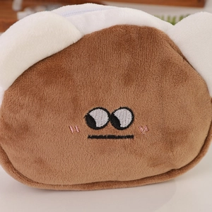 Macro shot of cute plush bear pouch with fine embroidery and white zipper closure