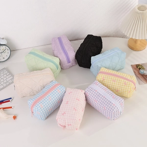 Detailed top view of various quilted cosmetic bags and stationery cases in ten colors