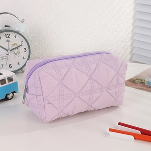 Macro shot of a lavender quilted pencil case with soft texture and zip closure