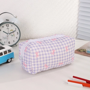 Macro shot of purple gingham quilted pencil case with cute pink bow pattern and zipper